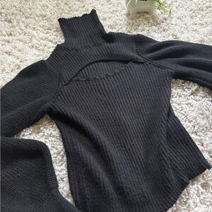 Black turtleneck sweater with cutout detail and bell sleeves for fall